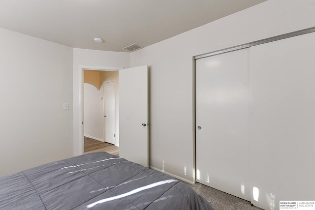 unfurnished bedroom with a closet and carpet flooring