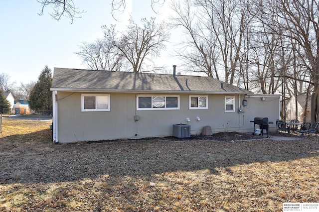 rear view of property with a patio area and central AC