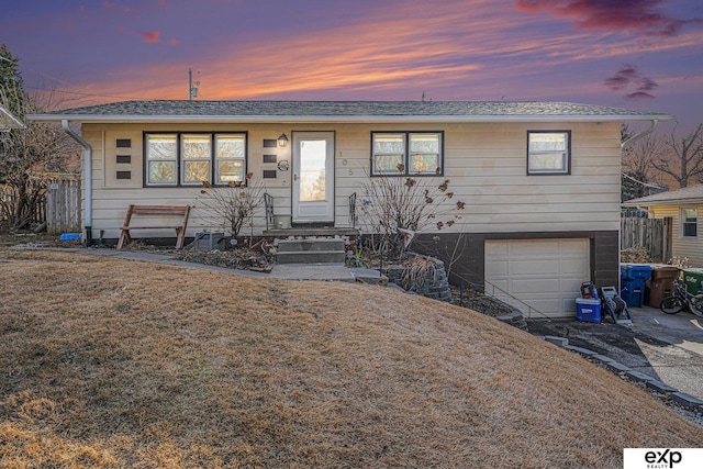 view of front of home featuring a garage and a yard