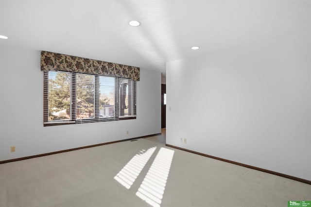 spare room with light colored carpet