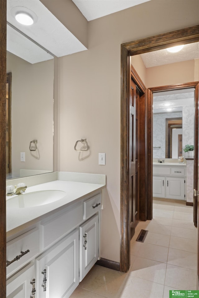 bathroom with vanity and tile patterned flooring