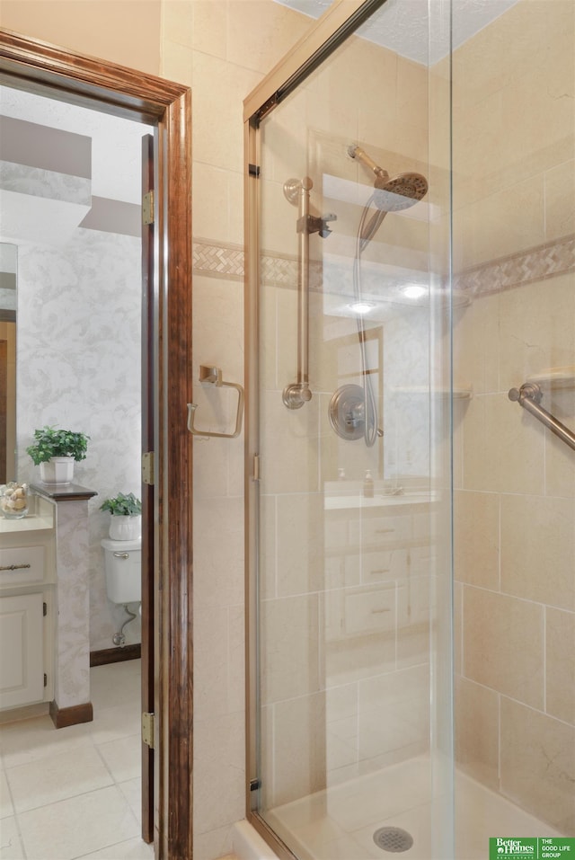 bathroom with a shower with shower door and toilet