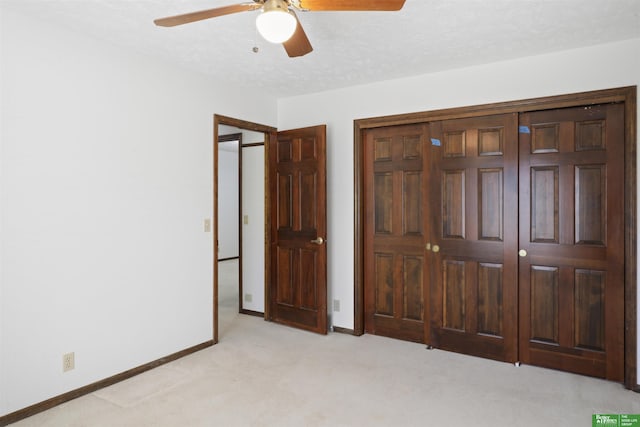 unfurnished bedroom with ceiling fan and light carpet