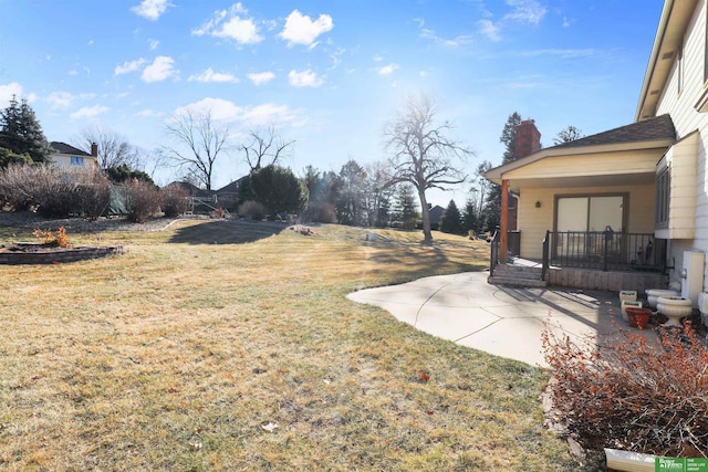 view of yard with a patio area and covered porch