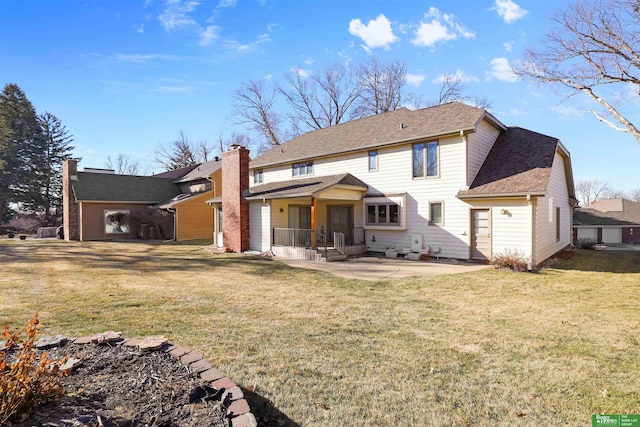 rear view of house featuring a patio area and a lawn