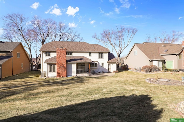 rear view of property featuring a lawn and a patio