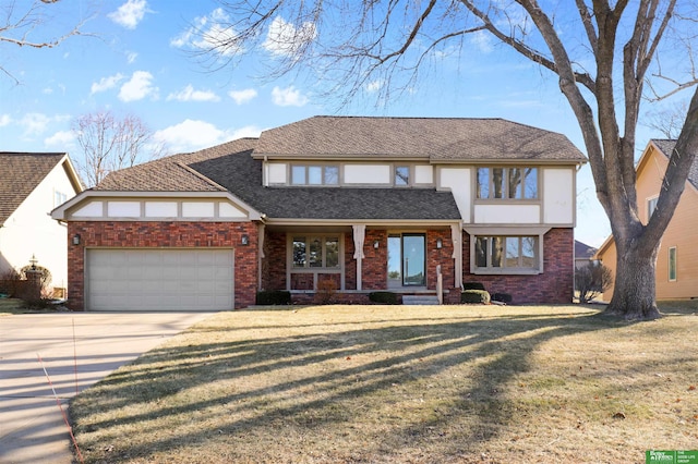 english style home with a front lawn and a garage