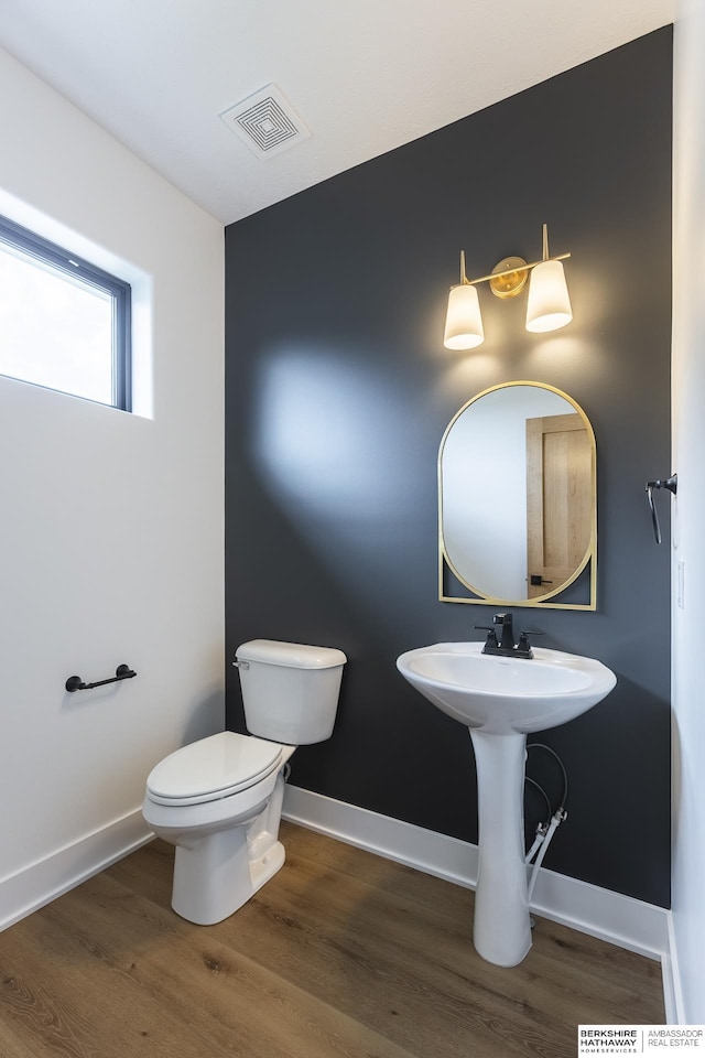 bathroom with toilet and hardwood / wood-style flooring