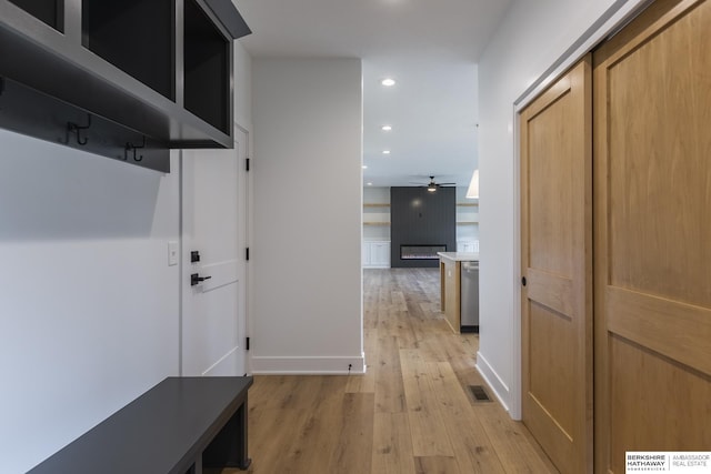 mudroom with ceiling fan and light hardwood / wood-style flooring