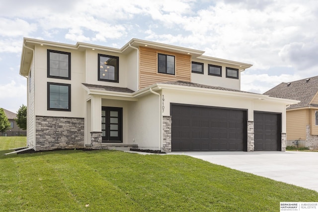 prairie-style home featuring a front lawn and a garage