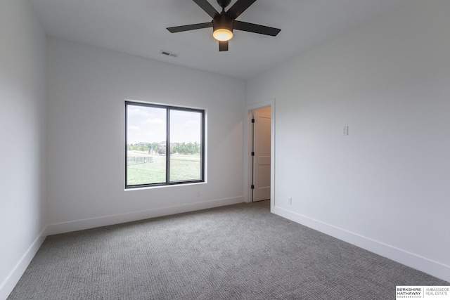 empty room featuring carpet floors and ceiling fan