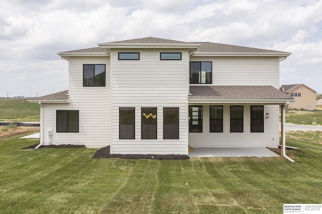 back of property with a patio area and a yard