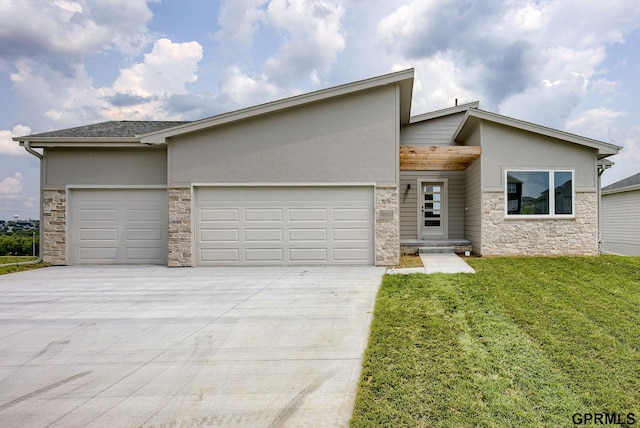 view of front of house with a garage and a front yard