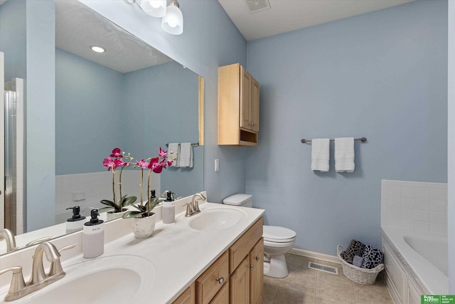 bathroom with toilet, tile patterned floors, a bathtub, and vanity