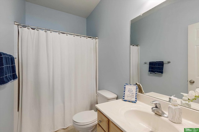 bathroom featuring toilet and vanity