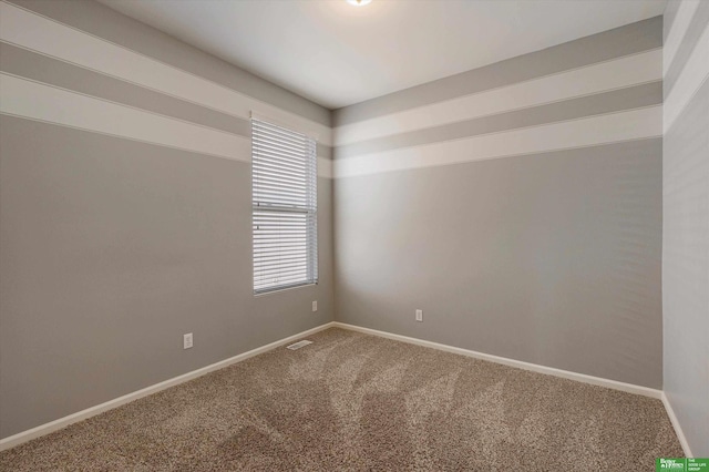 unfurnished room featuring carpet