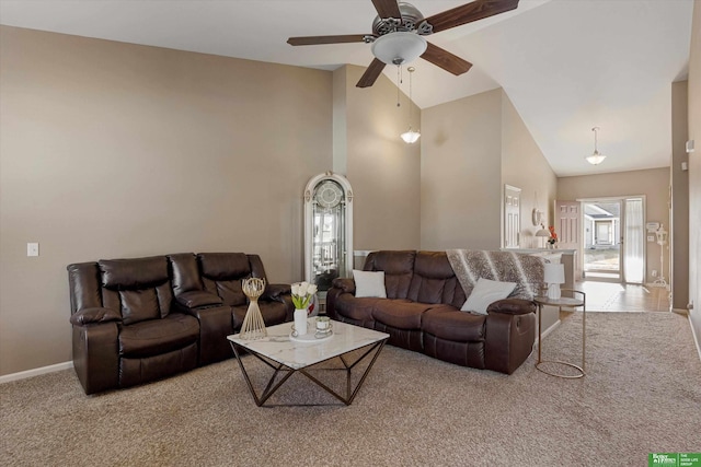 living room with light carpet, ceiling fan, a wealth of natural light, and high vaulted ceiling