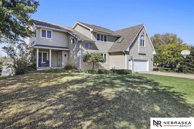 view of property featuring a front lawn, covered porch, and a garage