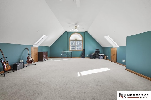 additional living space featuring ceiling fan, vaulted ceiling with skylight, and carpet