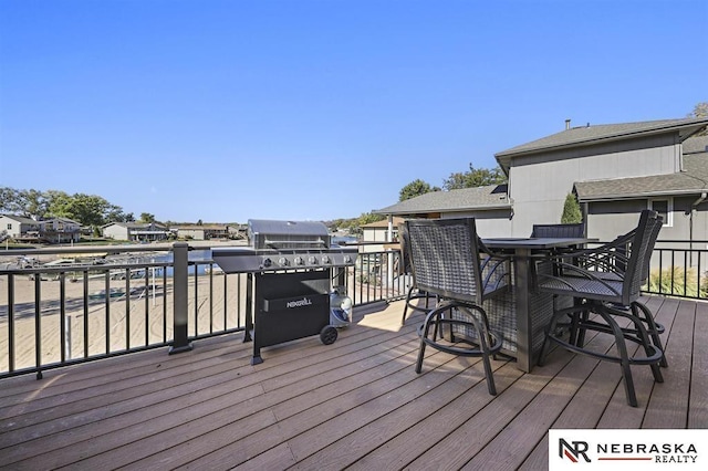 wooden deck featuring a grill