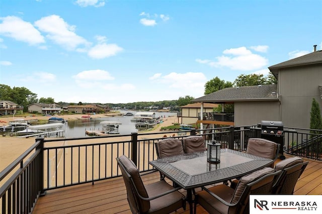 wooden deck featuring a water view and grilling area