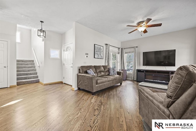 living room featuring ceiling fan and light wood-type flooring