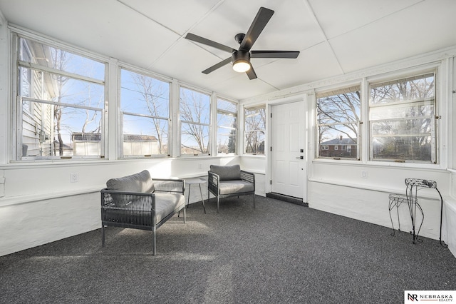 sunroom / solarium featuring ceiling fan