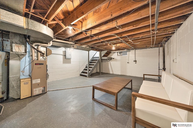 basement featuring electric panel and heating unit