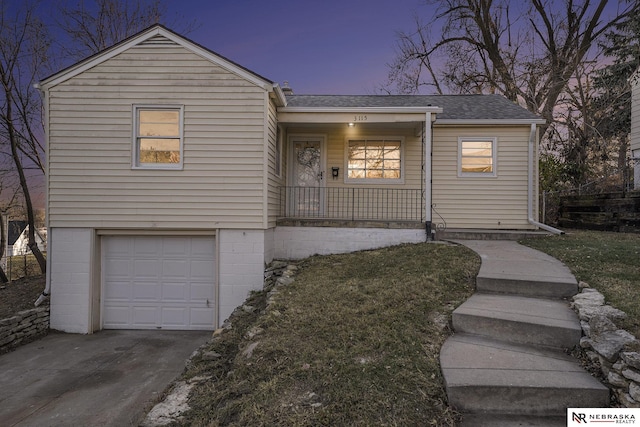 view of front of home featuring covered porch and a garage