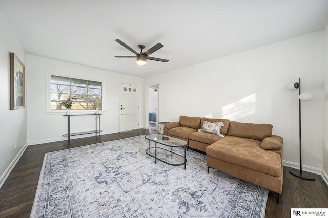 living room with dark wood-type flooring and ceiling fan