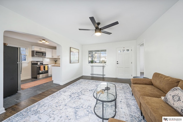 living room with ceiling fan and dark hardwood / wood-style floors