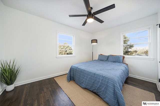 bedroom with dark wood-type flooring and ceiling fan