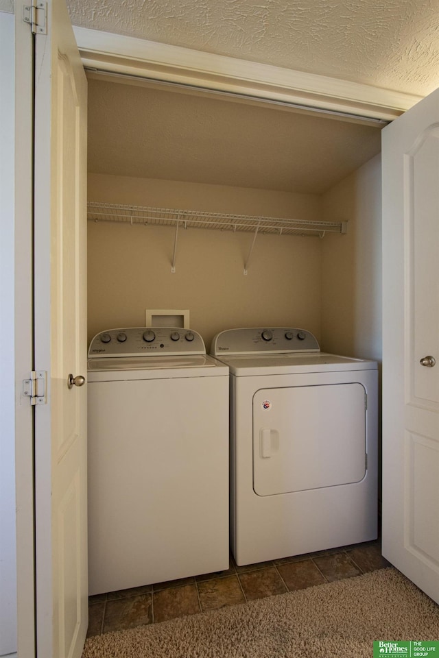 clothes washing area with washing machine and dryer