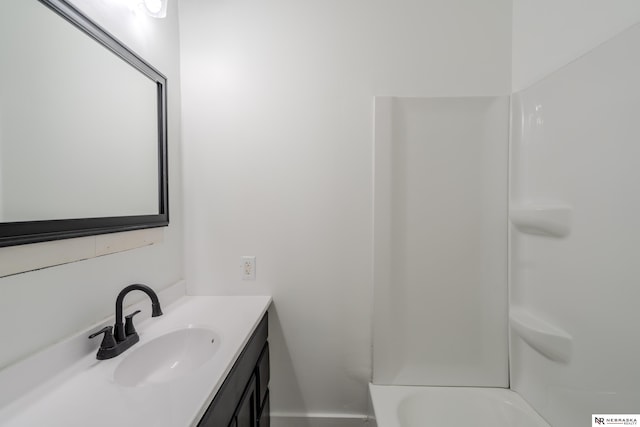 bathroom with vanity and bathing tub / shower combination