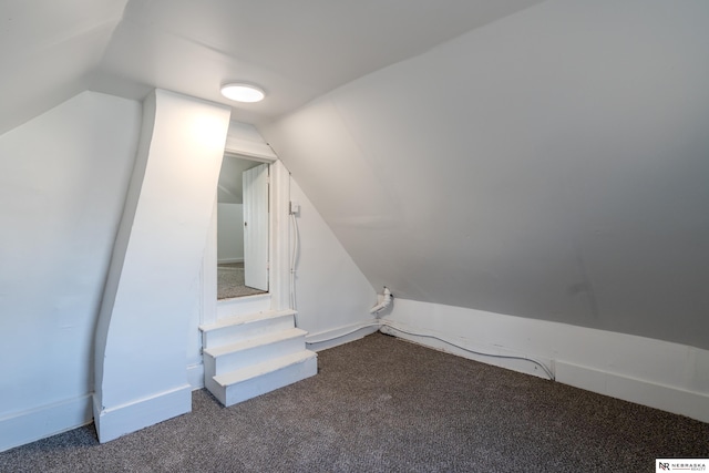 bonus room featuring vaulted ceiling and carpet