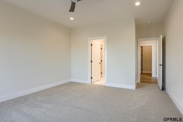 unfurnished bedroom featuring ceiling fan and light carpet