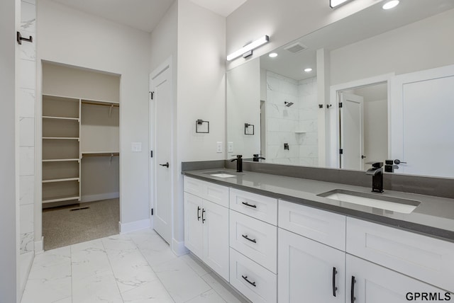 bathroom with walk in shower and vanity