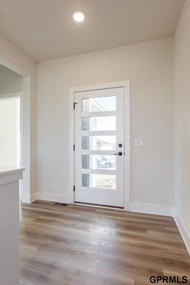 doorway to outside with light hardwood / wood-style flooring