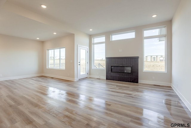 unfurnished living room with light wood-type flooring