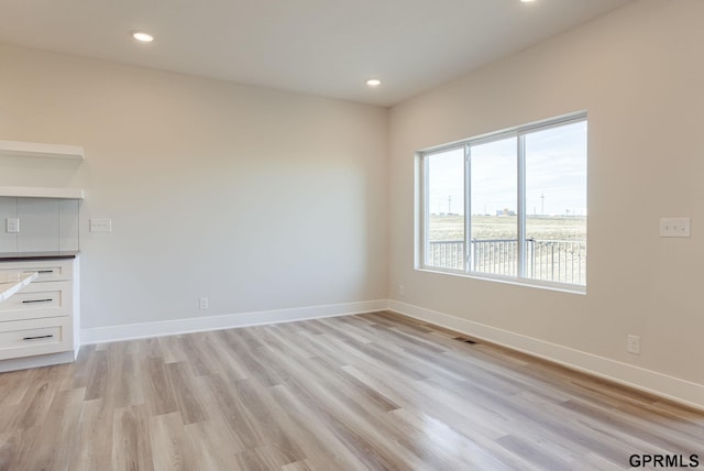 unfurnished room featuring light hardwood / wood-style floors