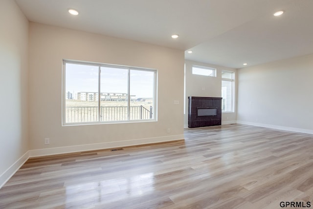 unfurnished living room with light hardwood / wood-style flooring