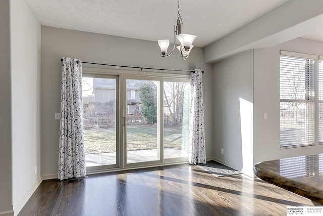 unfurnished dining area featuring a notable chandelier