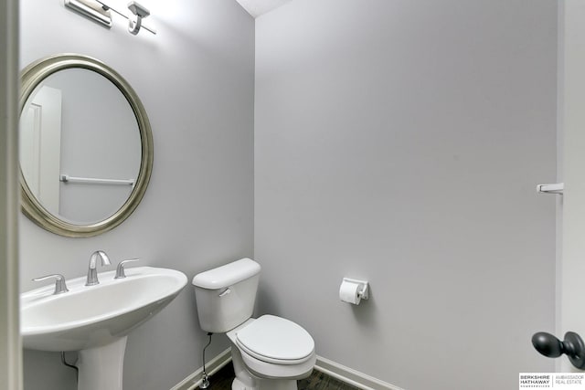 bathroom featuring toilet and sink