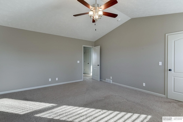 spare room with lofted ceiling, light colored carpet, and ceiling fan