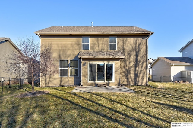 rear view of house with a lawn and a patio