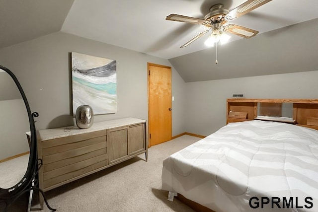 bedroom featuring ceiling fan, light carpet, and lofted ceiling