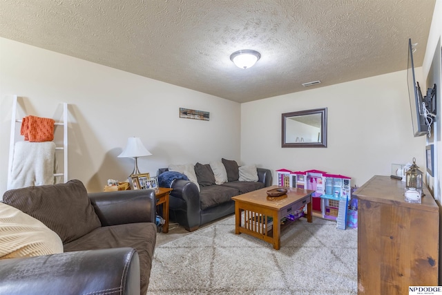 carpeted living room with a textured ceiling