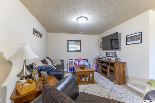 living room featuring light colored carpet and a textured ceiling