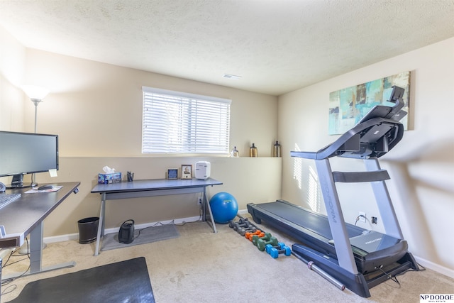 workout area featuring a textured ceiling