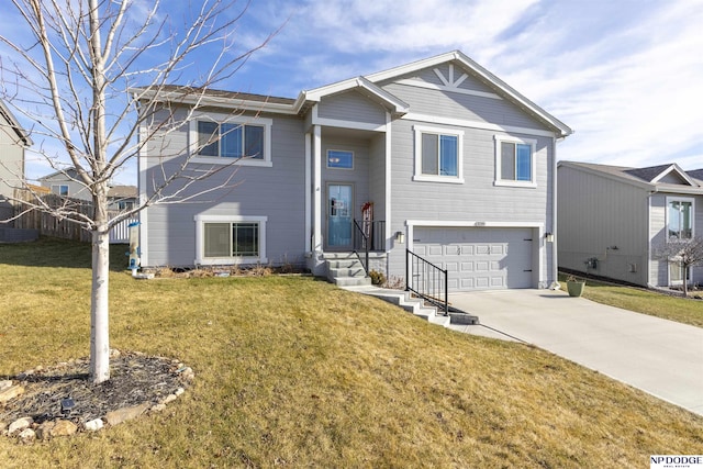 bi-level home featuring a front yard and a garage